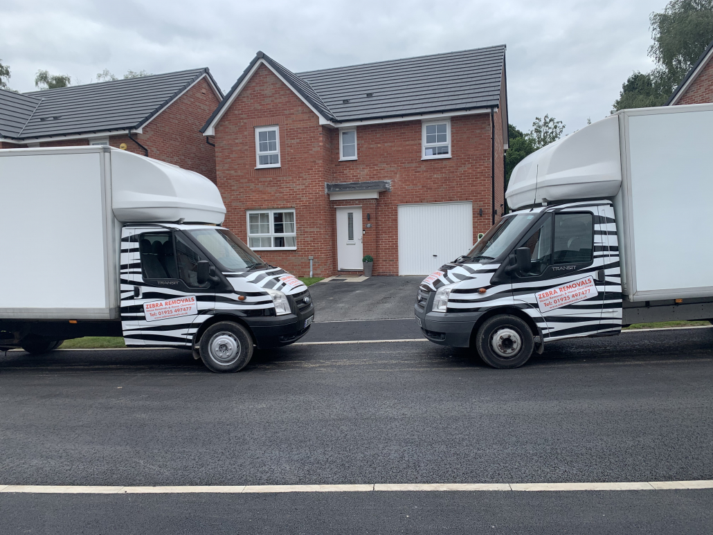 Two Luton vans from Zebra Removals carrying out a house clearance in Runcorn