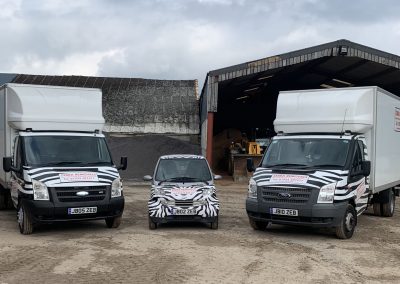 Two Zebra Removals vans and Zebra Removals Smart Car